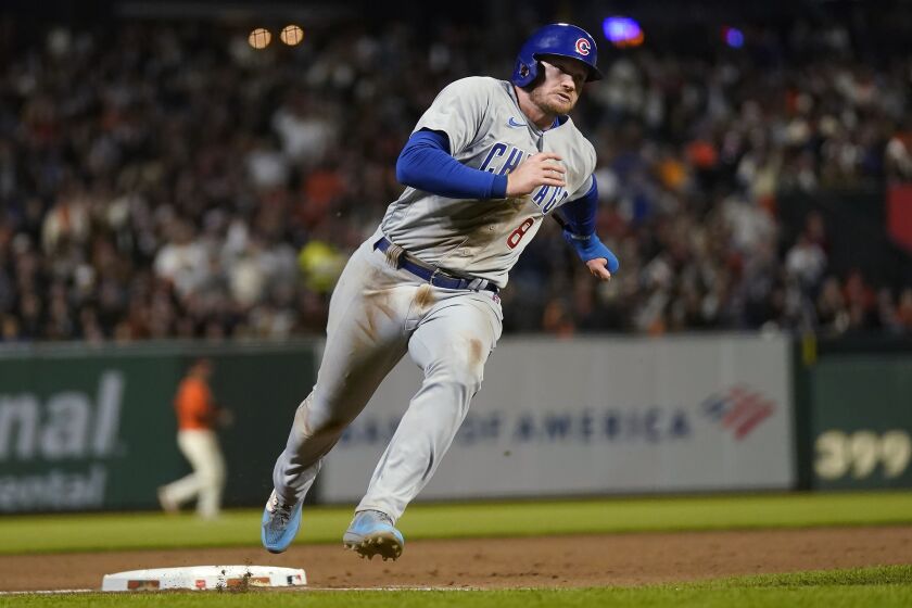 Chicago Cubs' Ian Happ rounds third on the way to scoring against the San Francisco Giants during the seventh inning of a baseball game in San Francisco, Friday, June 9, 2023. (AP Photo/Jeff Chiu)