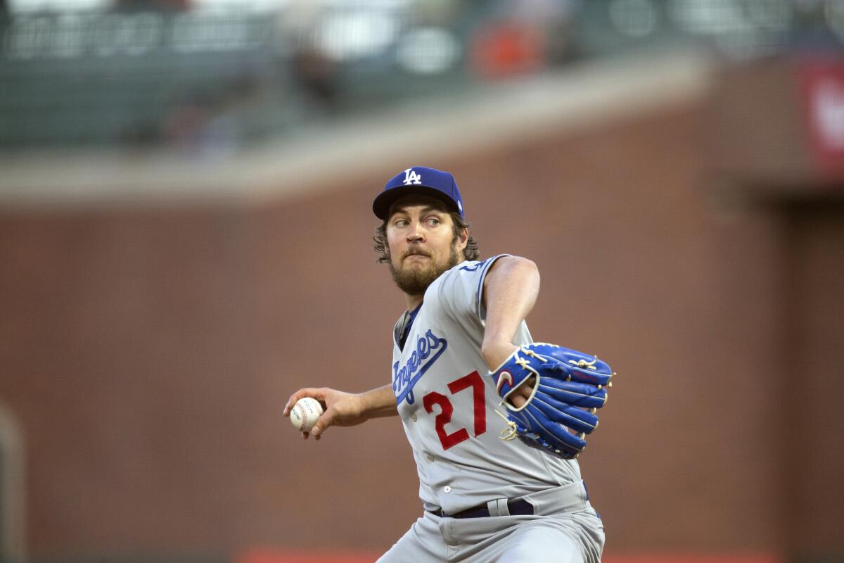 Dodgers starting pitcher Trevor Bauer winds up to throw the ball.