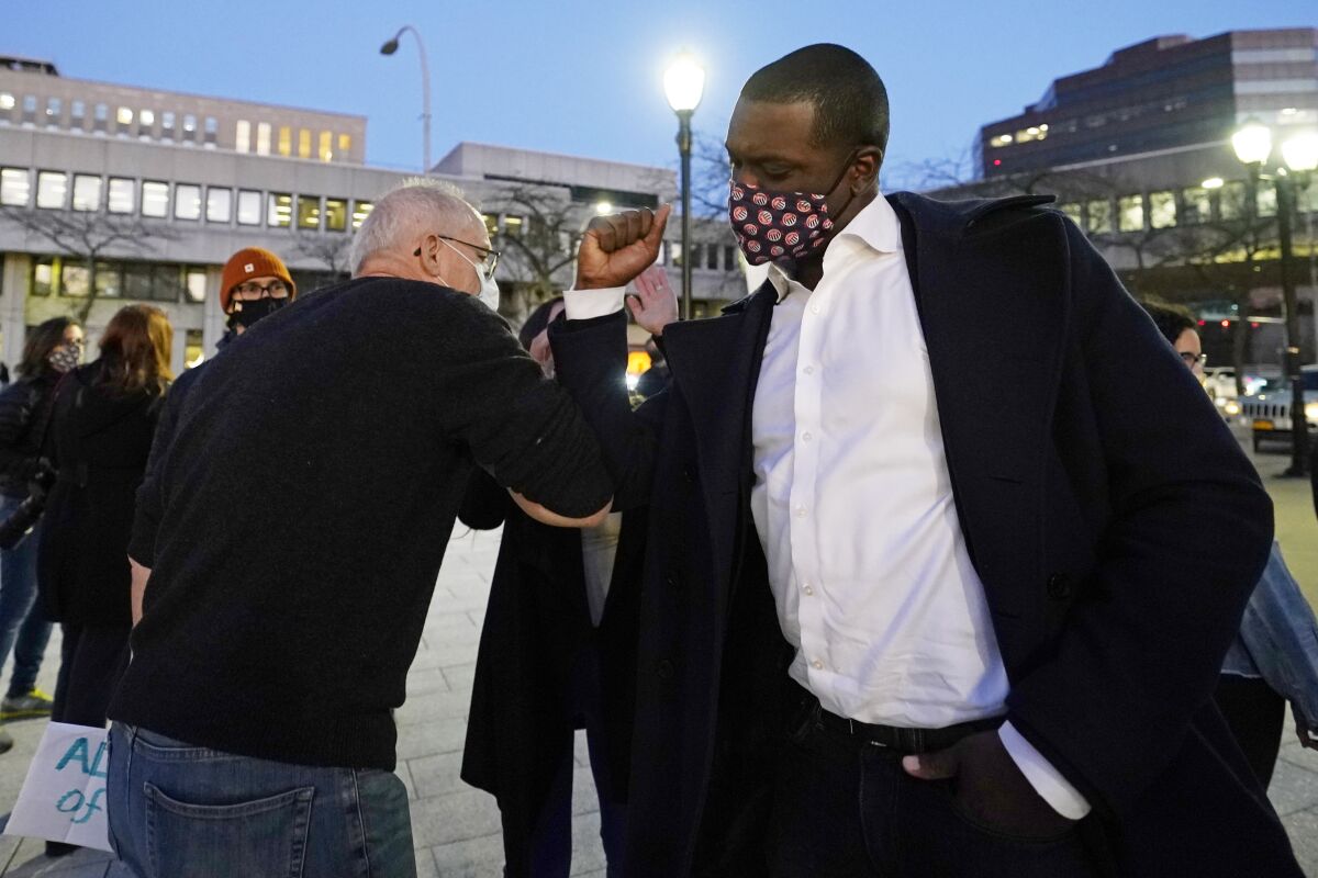 Rep.-elect Mondaire Jones, right, bumps elbows with a supporter Wednesday in White Plains, N.Y.