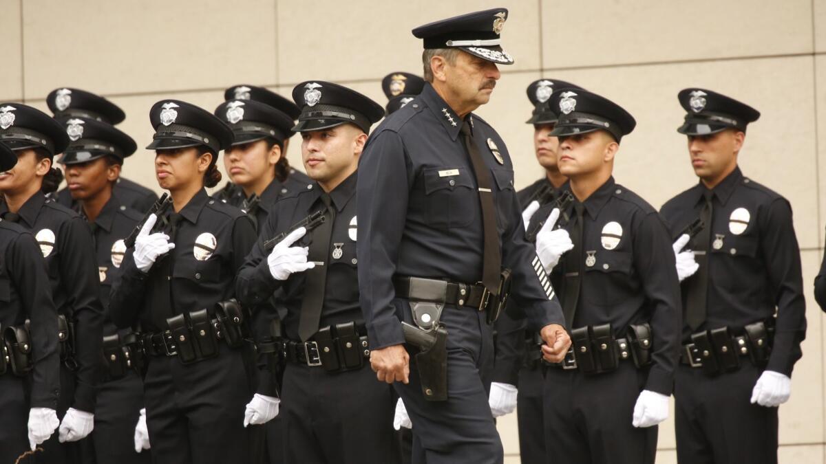 LAPD Chief Charlie Beck conducts inspection of new police officers at a graduation ceremony.