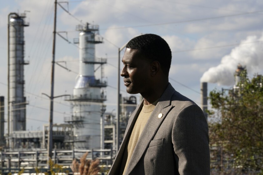 EPA Administrator Michael Regan stands near the Marathon Petroleum Refinery as he conducts a television interview, while touring neighborhoods that abut the refinery, in Reserve, La., Tuesday, Nov. 16, 2021. Regan visited St. John and St. James parishes on a tour he called "Journey to Justice." The five-day trip from Mississippi to Texas in mid-November highlighted low-income, mostly minority communities adversely affected by decades of industrial pollution. (AP Photo/Gerald Herbert)