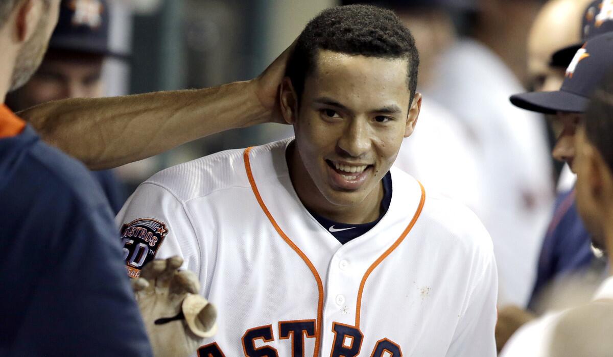 Houston Astros' Carlos Correa is congratulated in the dugout after hitting a solo home run against the Tampa Bay Rays on Aug. 19.