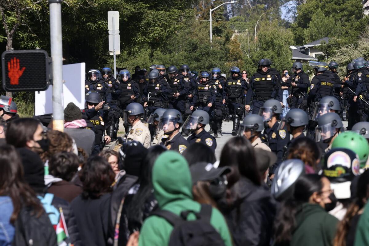 Police in riot gear stand off against pro-Palestinian demonstrators at the University 