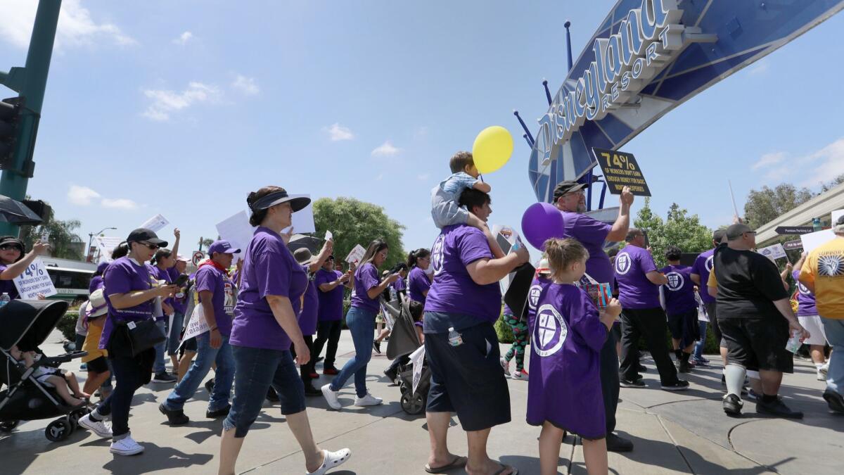 Disneyland workers demonstrate for higher wages at the entrance to the Disneyland Resort in Anaheim on July 3.