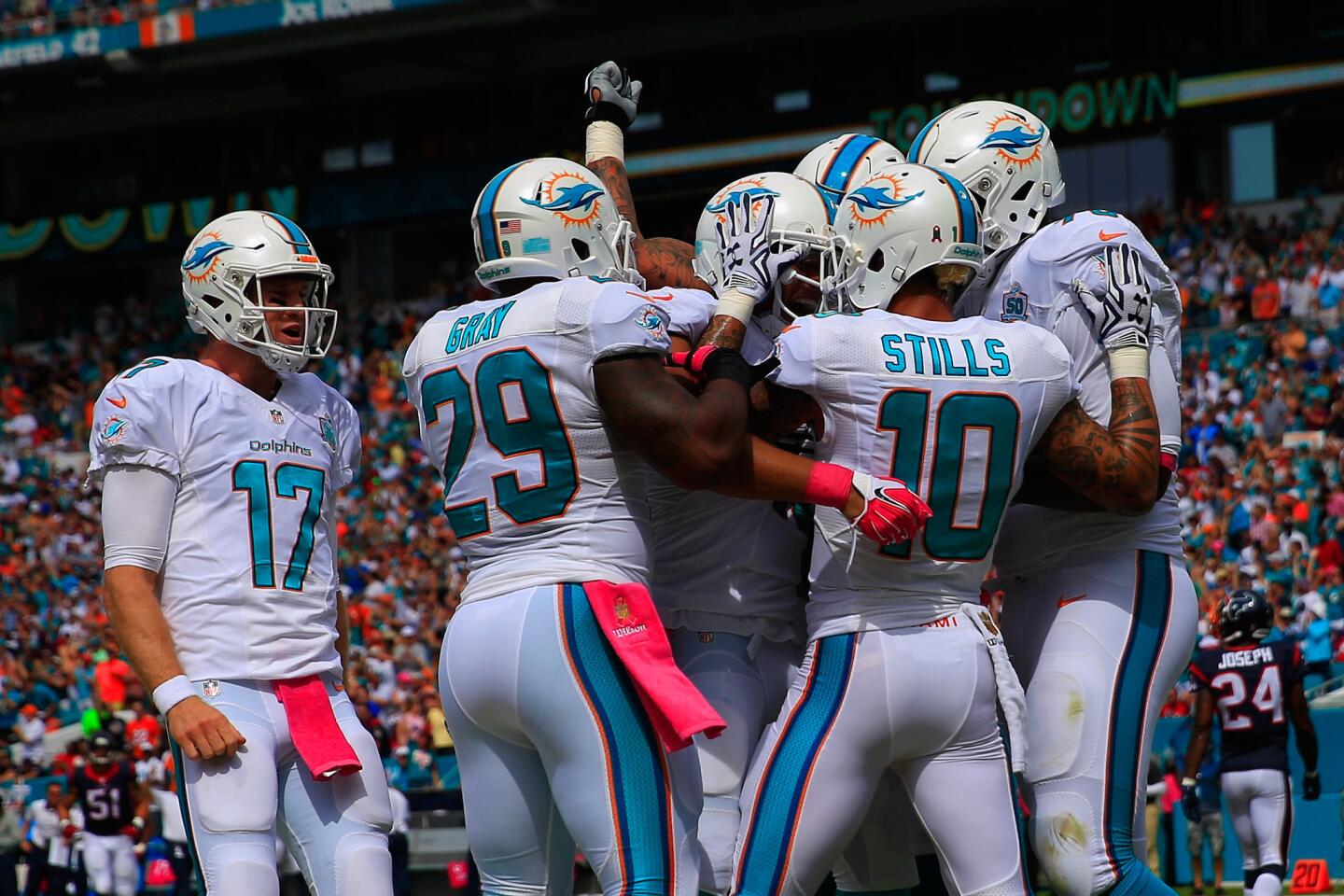 MIAMI GARDENS, FL - OCTOBER 25: Rishard Matthews #18 of the Miami Dolphins is congratulated by his teammates for a touchdown in the first quarter during a game against the Houston Texans at Sun Life Stadium on October 25, 2015 in Miami Gardens, Florida. (Photo by Chris Trotman/Getty Images) ORG XMIT: 570292009