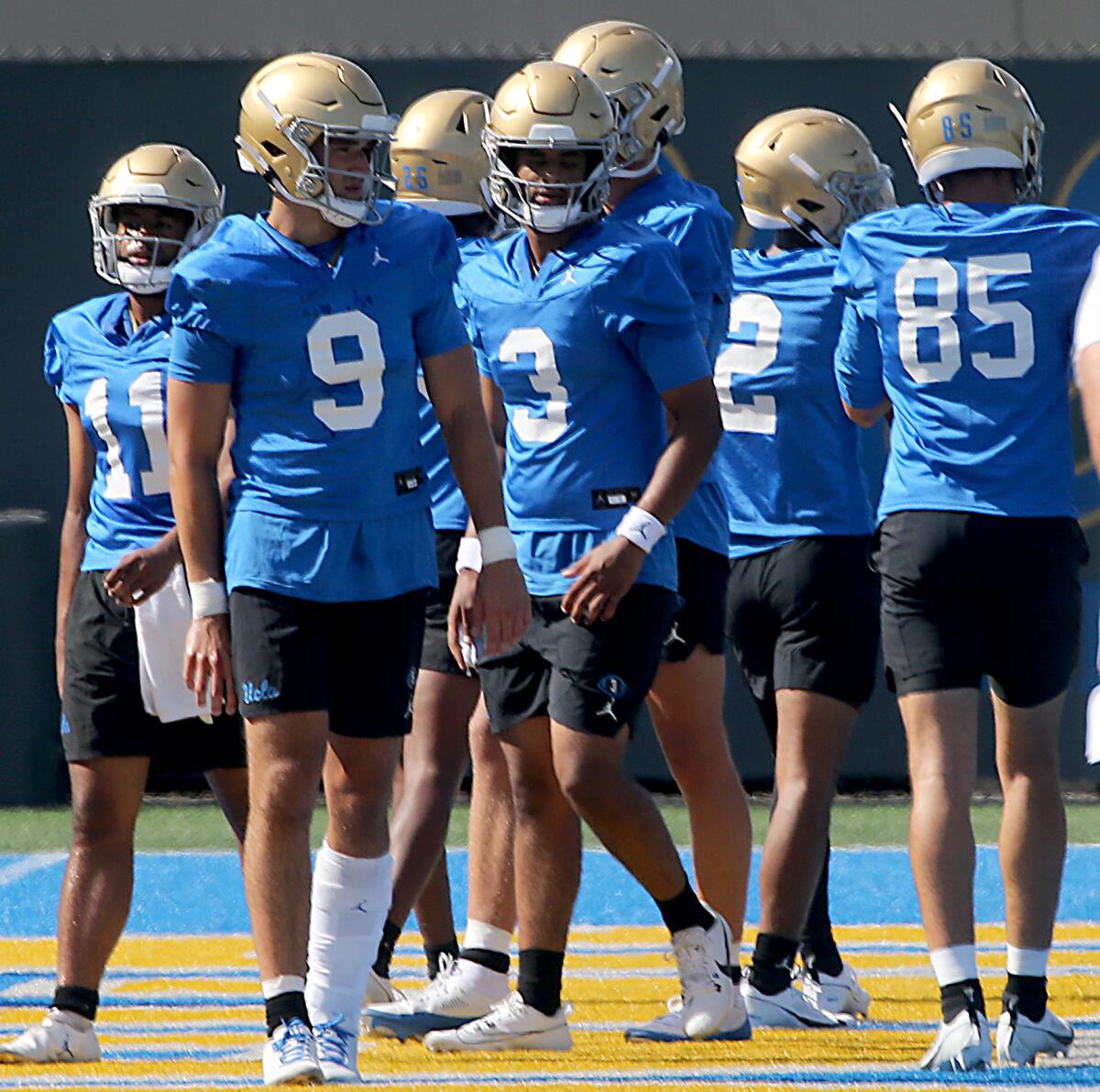UCLA quarterback Dante Moore warms up during a preseason practice session.