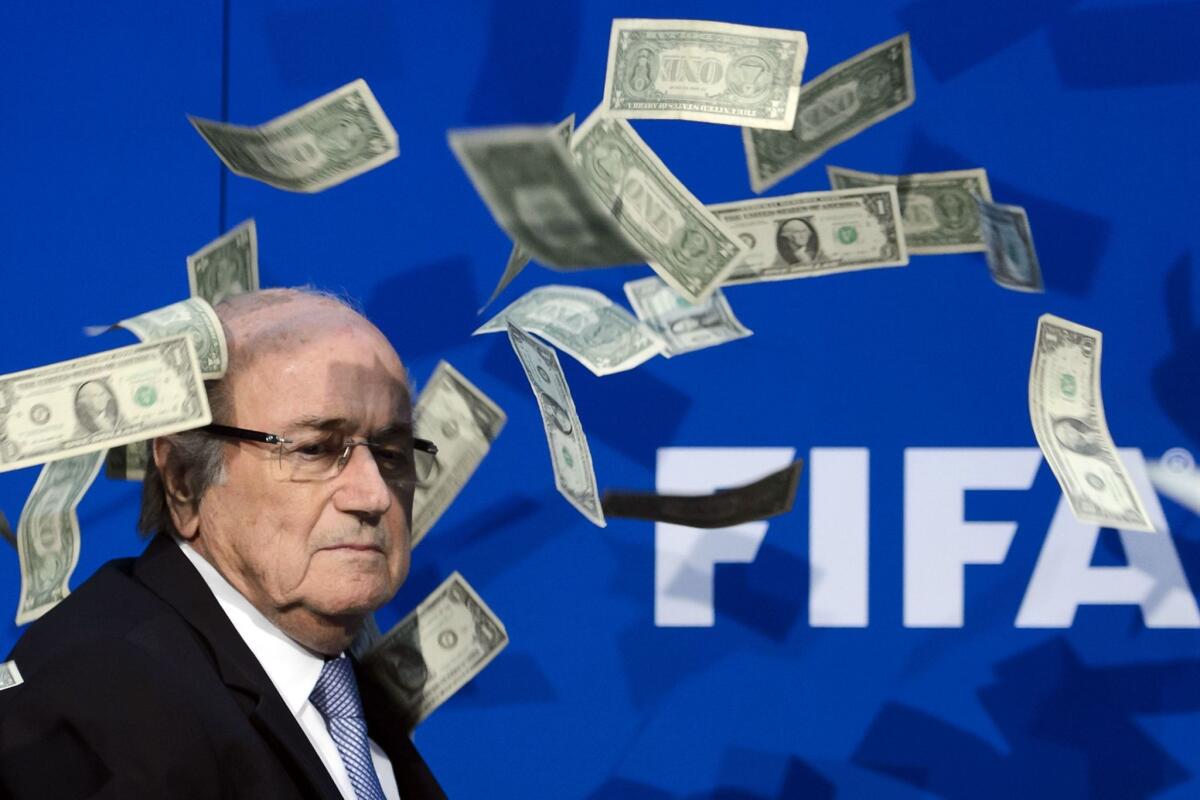 Former FIFA president Sepp Blatter looks on after a protester threw fake dollars at him during a news conference on July 20, 2015, in Zurich, Switzerland.