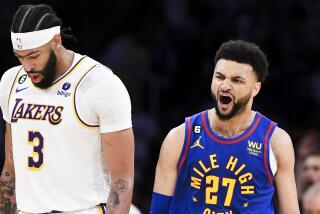 Nuggets guard Jamal Murray (27) celebrates after making a three-point shot against Anthony Davis (3) and the Lakers in Game 3