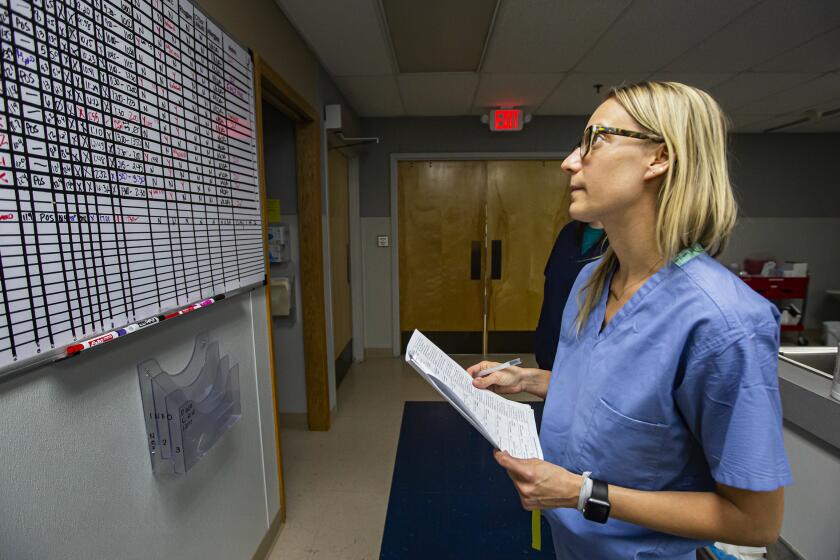 Dr. Angela Marchin checks the schedule as she charts her patients after a long day at the Trust Women Wichita Clinic Tuesday. Dr. Marchin flies in from Colorado twice a month for two days to help out. The abortion clinic is seeing more patients from out-of state due to anti-choice measures in those states.