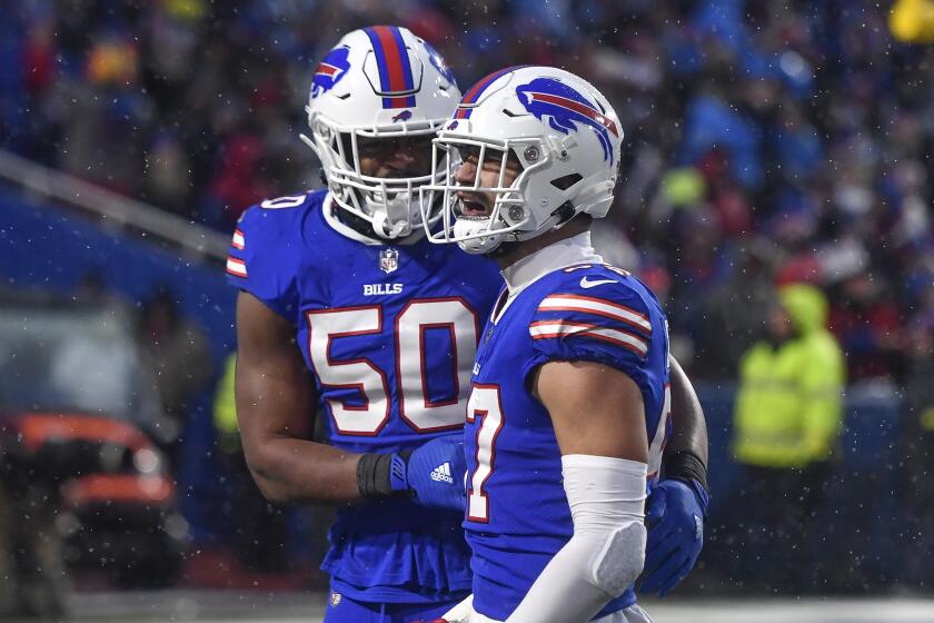 Buffalo Bills defensive end A.J. Epenesa (57) celebrates with defensive end Greg Rousseau (50) after a defensive stop against the New York Jets during the second half of an NFL football game in Orchard Park, N.Y., Sunday, Dec. 11, 2022. (AP Photo/Adrian Kraus)