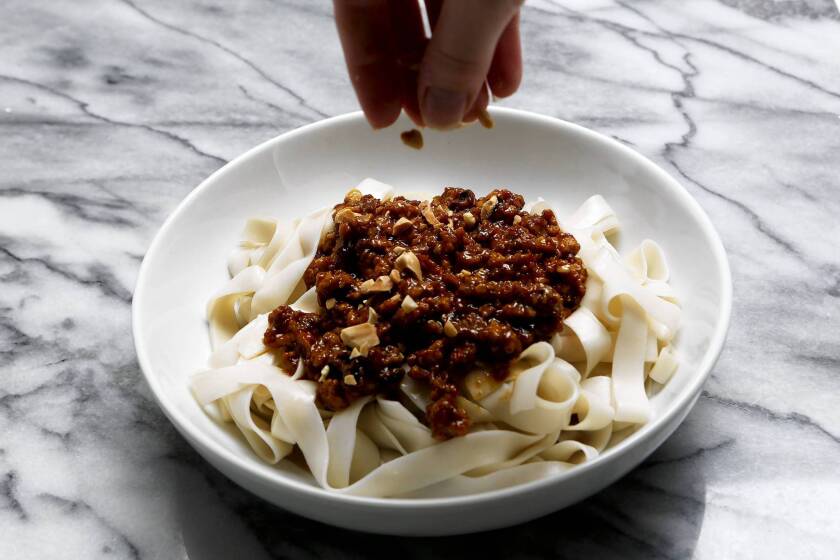 For dandan noodles, a pork mixture is spooned over nooles and the dish is then topped with a sesame sauce and peanuts. Recipe: Dandan noodles