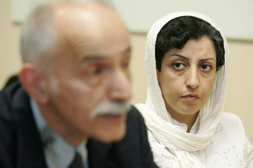 FILE - Iranian Narges Mohammadi, right, from the center for Human Rights Defenders, listens to Karim Lahidji, president of the Iranian league for the Defence of Human Rights, during a press conference on the Assessment of the Human Rights Situation in Iran, at the UN headquarters in Geneva, Switzerland, June 9, 2008. Paris-based Taghi Rahmani, the husband of Mohammadi, a prominent human rights activist, said his wife has been sentenced to more than eight years in prison in Iran. He said in a tweet Sunday, Jan. 23, 2022, that his wife, Narges Mohammadi, was tried in five minutes and sentenced to prison and 70 lashes and that she also has been prohibited from using phones or computers to communicate. (AP Photo/Keystone/Magali Girardin, File)