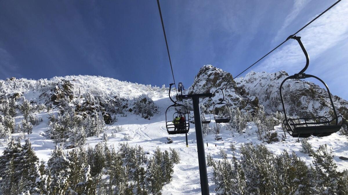 Skiers travel up a lift at Mammoth Mountain ski resort in Mammoth Lakes on Dec. 7.