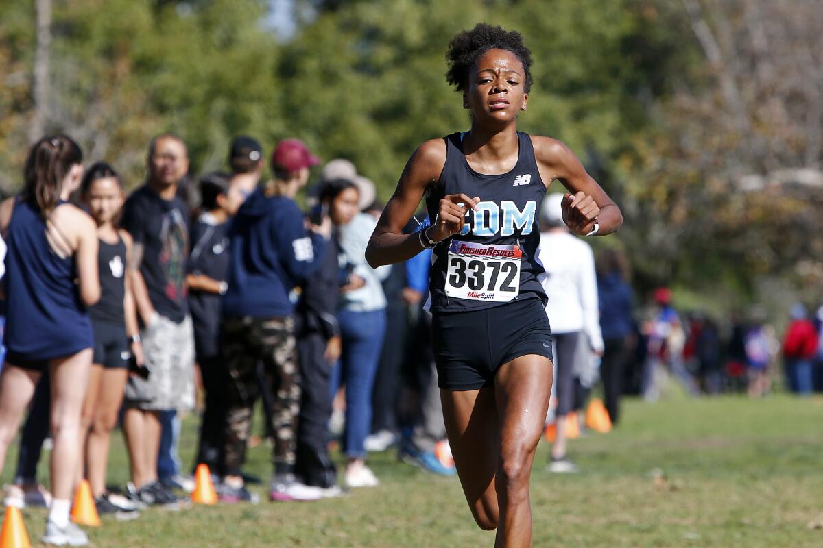 Corona del Mar's Melisse Djomby-Enyawe  approaches the finish line in the Sunset Conference cross-country finals.