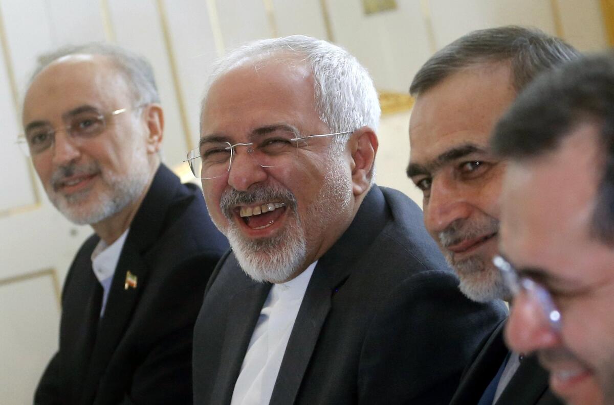 Iranian Foreign Minister Mohammad Javad Zarif laughs during a meeting with U.S. Secretary of State John F. Kerry at a hotel in Vienna on Tuesday.