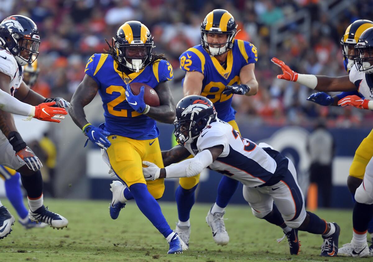 Los Angeles Rams' Todd Gurley II (left) is tackled by Cincinnati