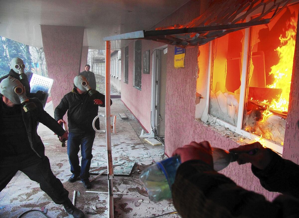 Pro-Russia protesters attack a regional police building in Horlivka, in eastern Ukraine.