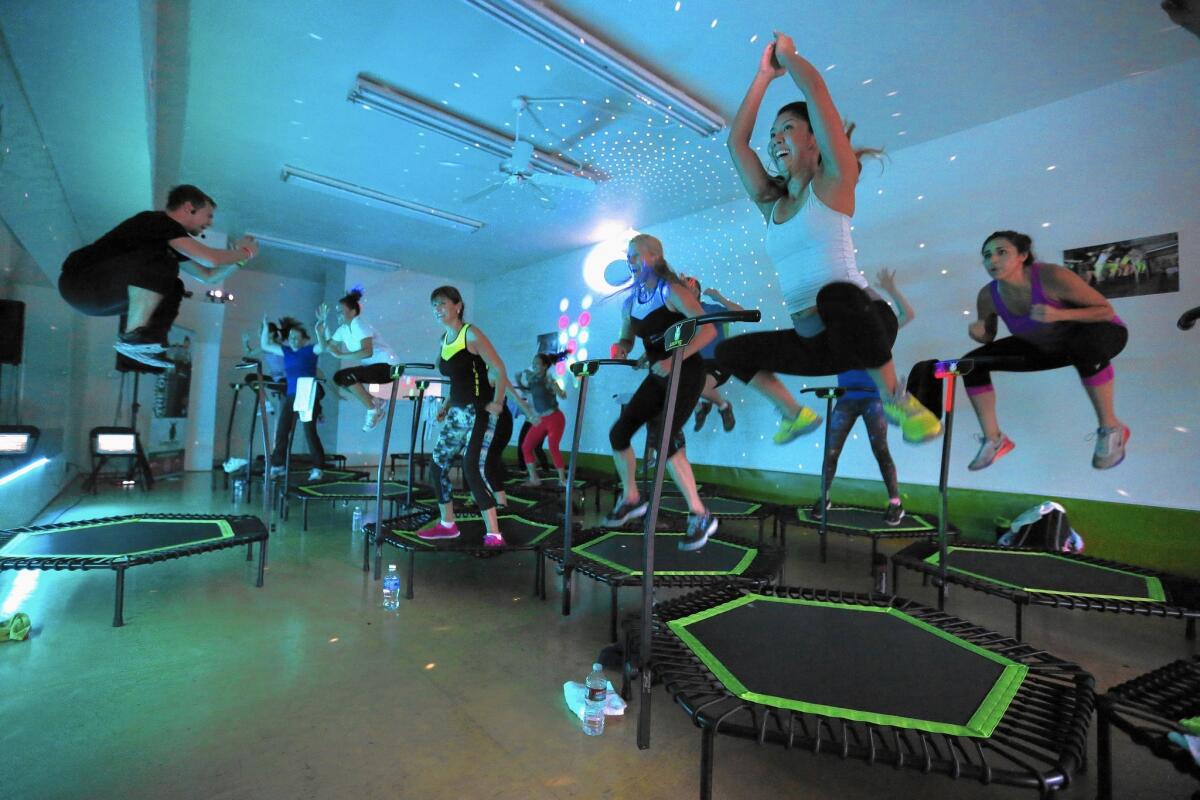 Jumping class is some serious bouncing around. Jakub Novotny, left, leads a group at Jumping Fitness in Redondo Beach.
