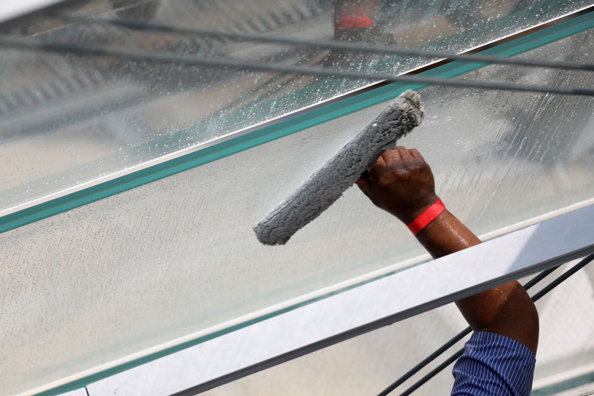 A maintenance worker cleans the glass dome 