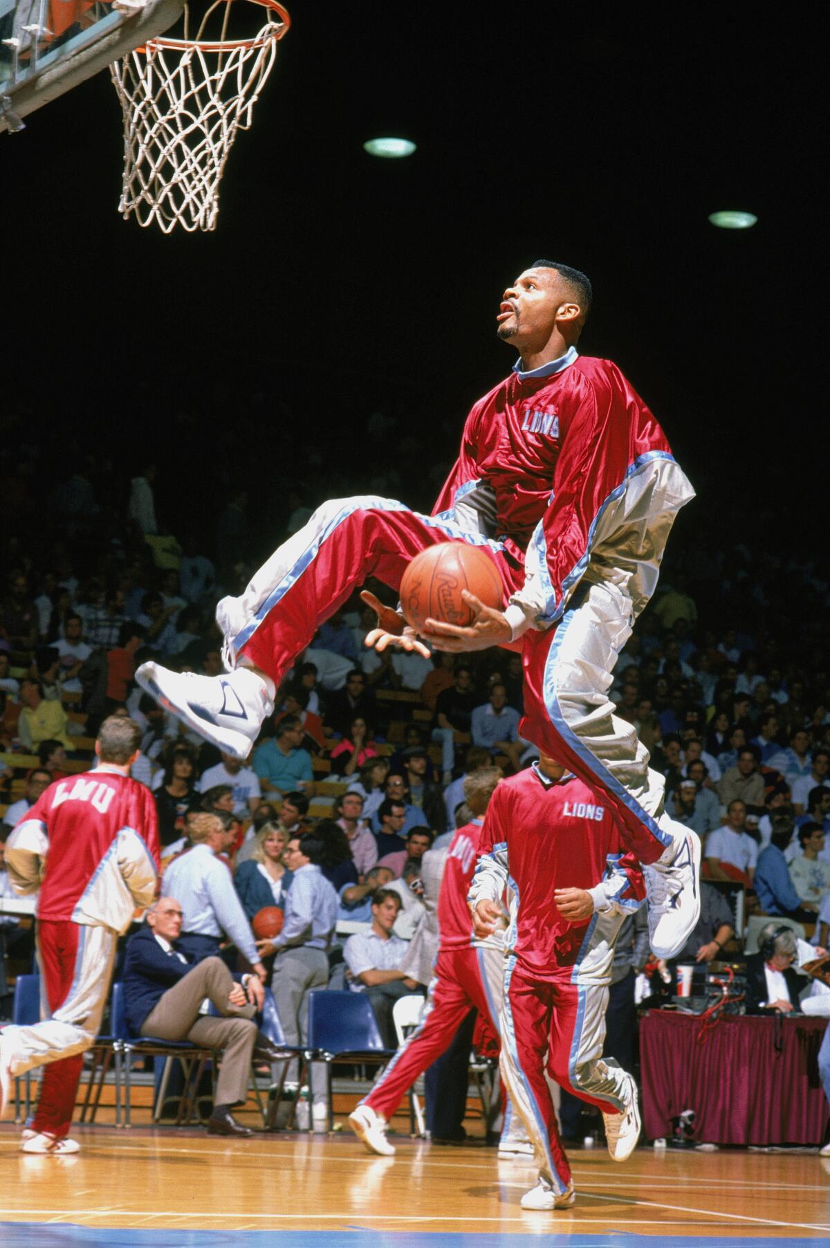 Loyola Marymount's Hank Gathers drives for a through-the-legs layup during warmups in 1990.