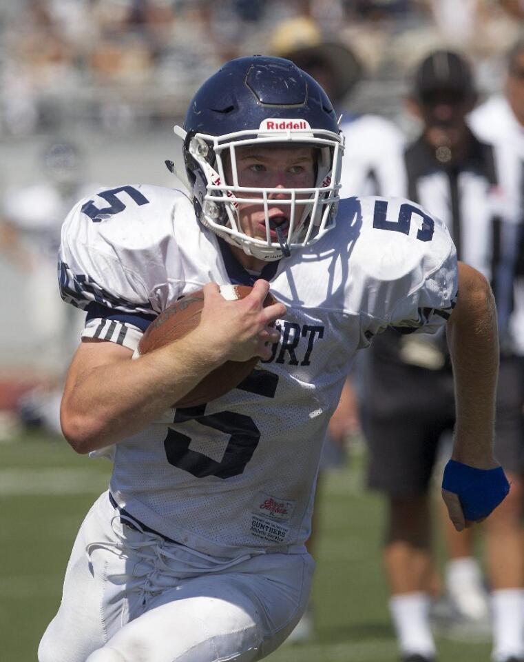 Newport Harbor High's Cole Kinder runs witht he ball during a scrimmage against Estancia at Jim Scott Stadium on Friday.