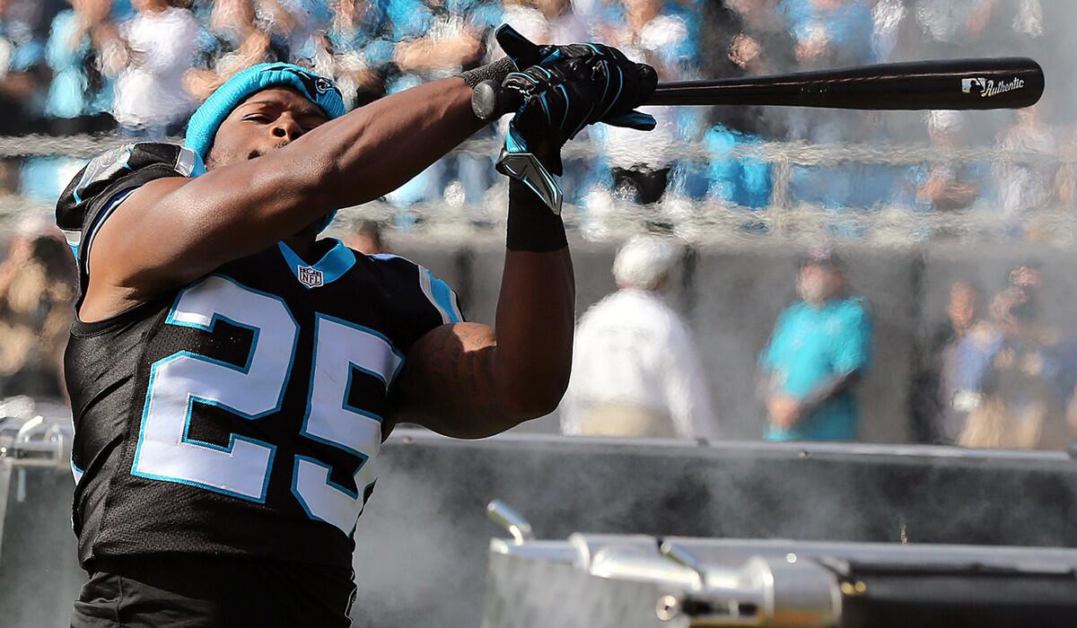 Panthers defender Bene Benwikere swings a bat as he takes the field to play the Atlanta Falcons on Dec. 13.