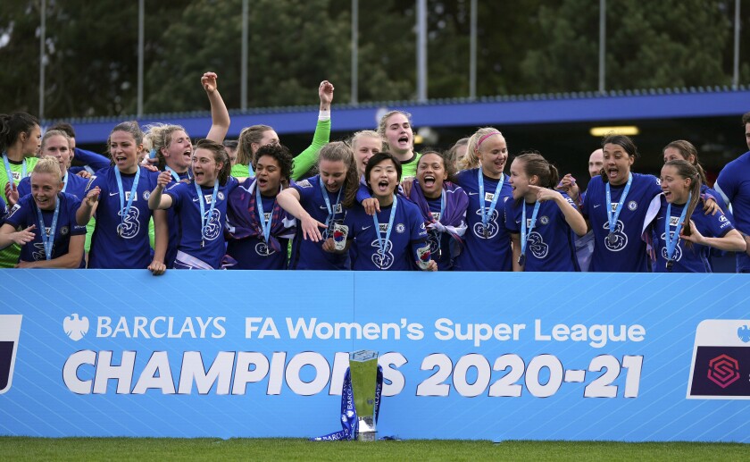 Chelsea players celebrate with the Women's Super League trophy at Kingsmeadow, London, Sunday, May 9, 2021. Chelsea retained the Women’s Super League title and became the all-time record champion in the English game by beating Manchester City to first place. Chelsea was a 5-0 winner at home to Reading and finished two points ahead of City. (John Walton/PA via AP)