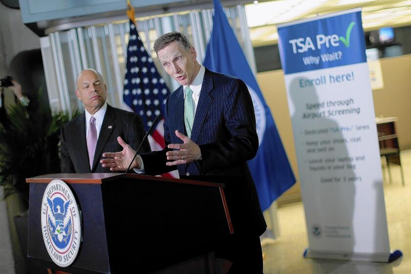 Transportation Security Administration Administrator John Pistole, right, speaks at the opening of a new TSA Pre-check application center in Virginia. In an interview, Pistole responds to the agency's critics and talks about the future of airport security.