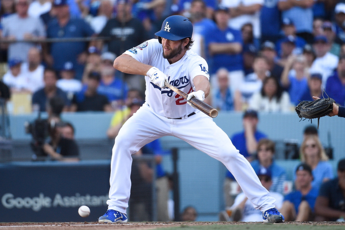 Dodgers pitcher Clayton Kershaw bunts during a playoff game against the Brewers.