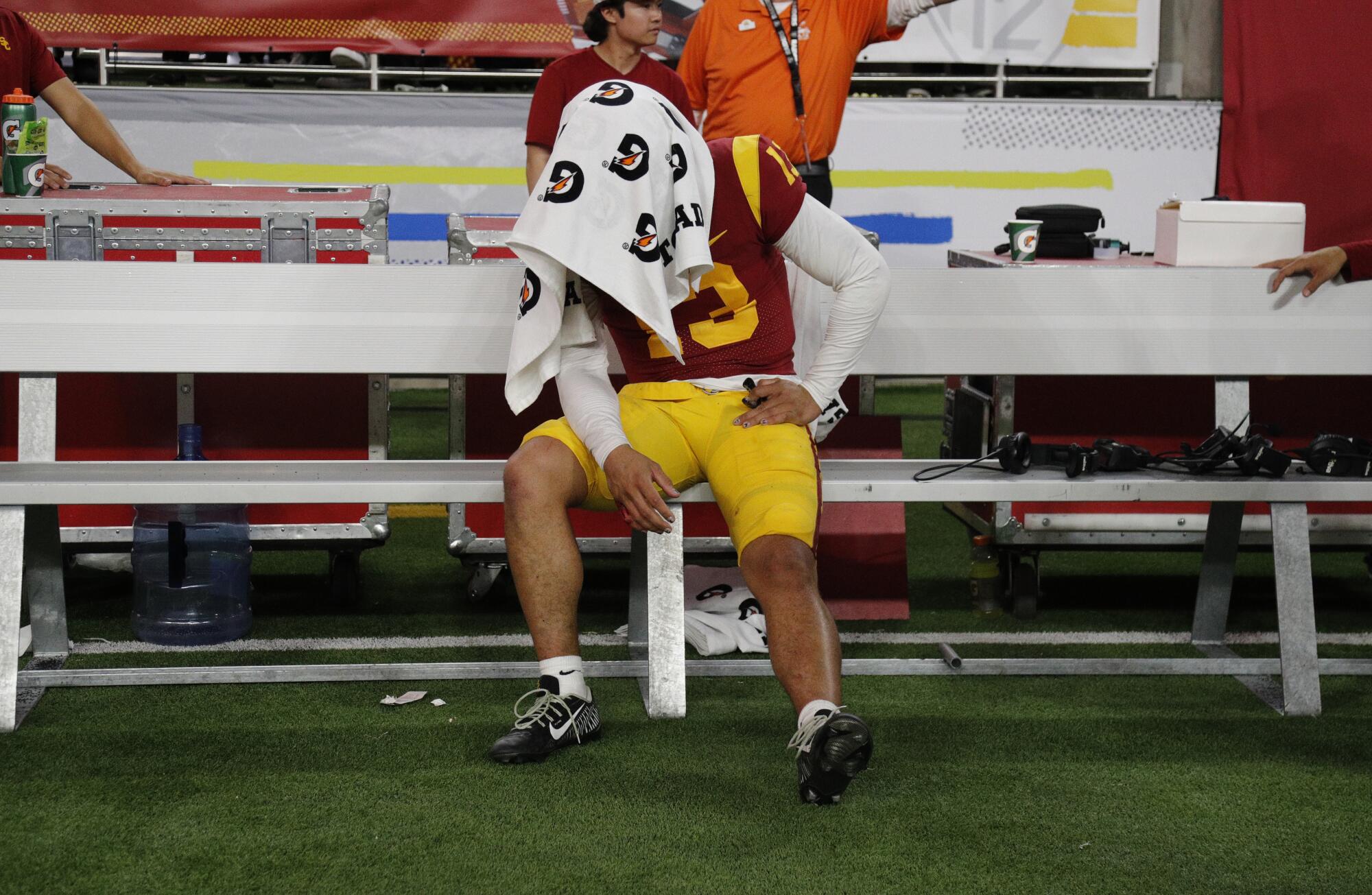 USC quarterback Caleb Williams sits under a towel after the Trojans lost to Utah in the Pac-12 championship game