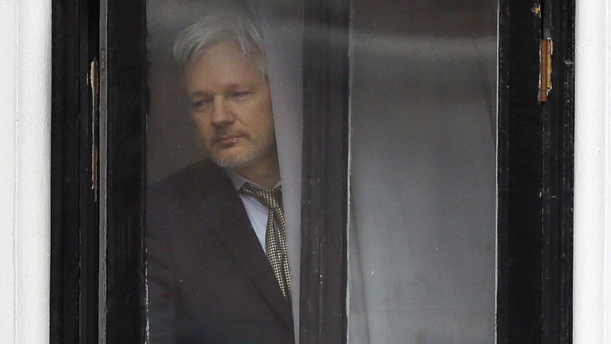 Wikileaks founder Julian Assange walks onto the balcony of the Ecuadorean Embassy in London on Feb. 5, 2016.