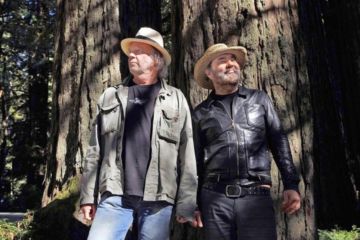 Neil Young, left, and record producer Daniel Lanois worked on the new album, "Le Noise." They were both photographed amoung the redwood trees near the Mountain House Restaurant in Woodside, Calif.