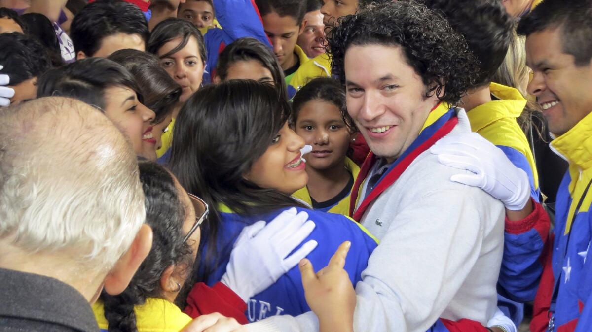 Gustavo Dudamel among students in Caracas, Venezuela, in 2012.