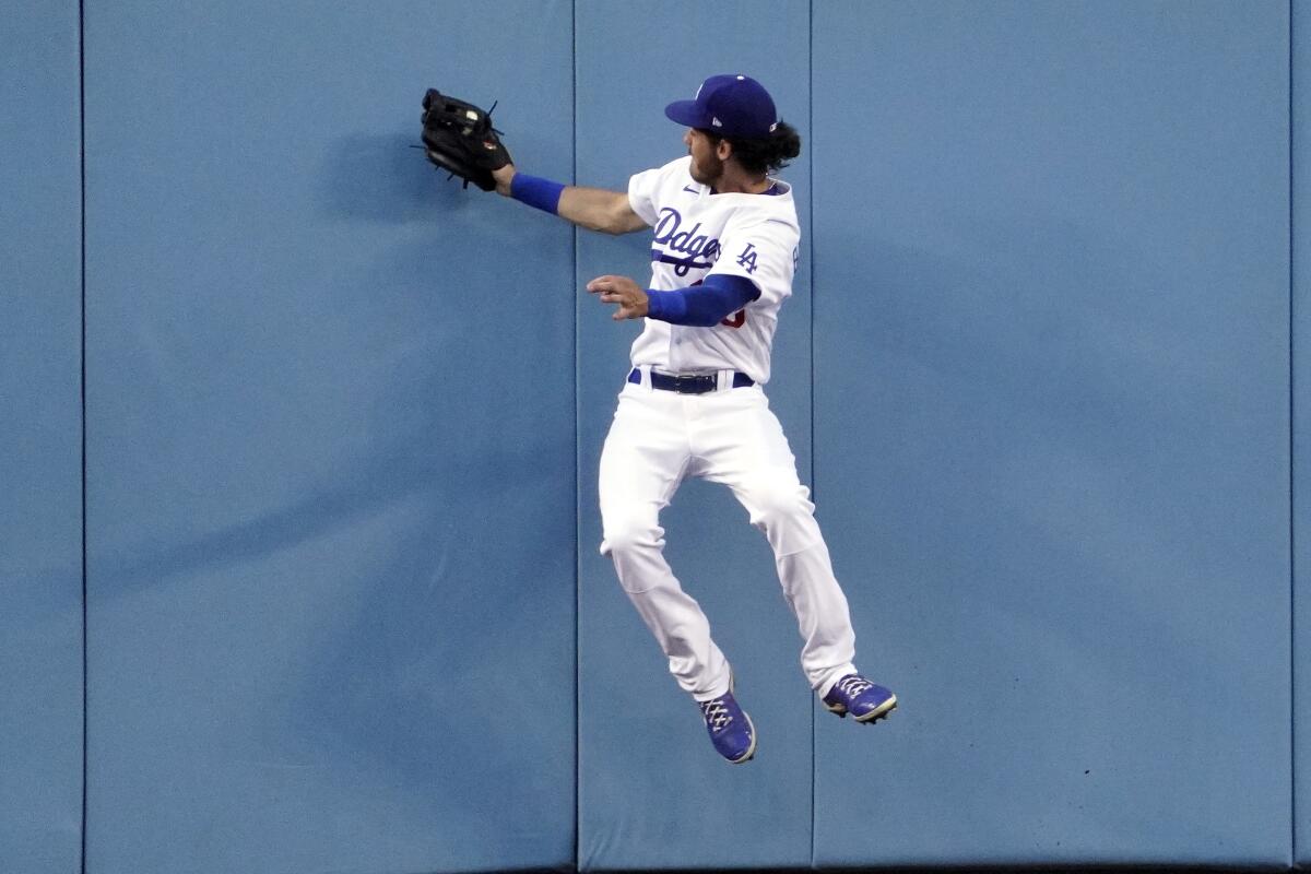 Dodgers center fielder Cody Bellinger makes a catch at the wall on a ball hit by Texas Rangers' Joey Gallo.