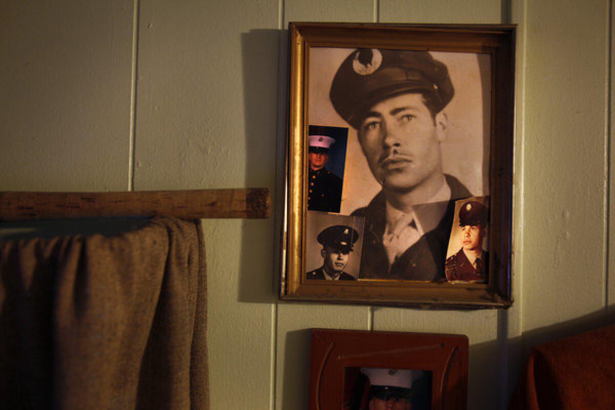 On the wall of his home, Mark Tyree has hung photos of himself, his father, his deceased son, and his brother -- all military veterans.