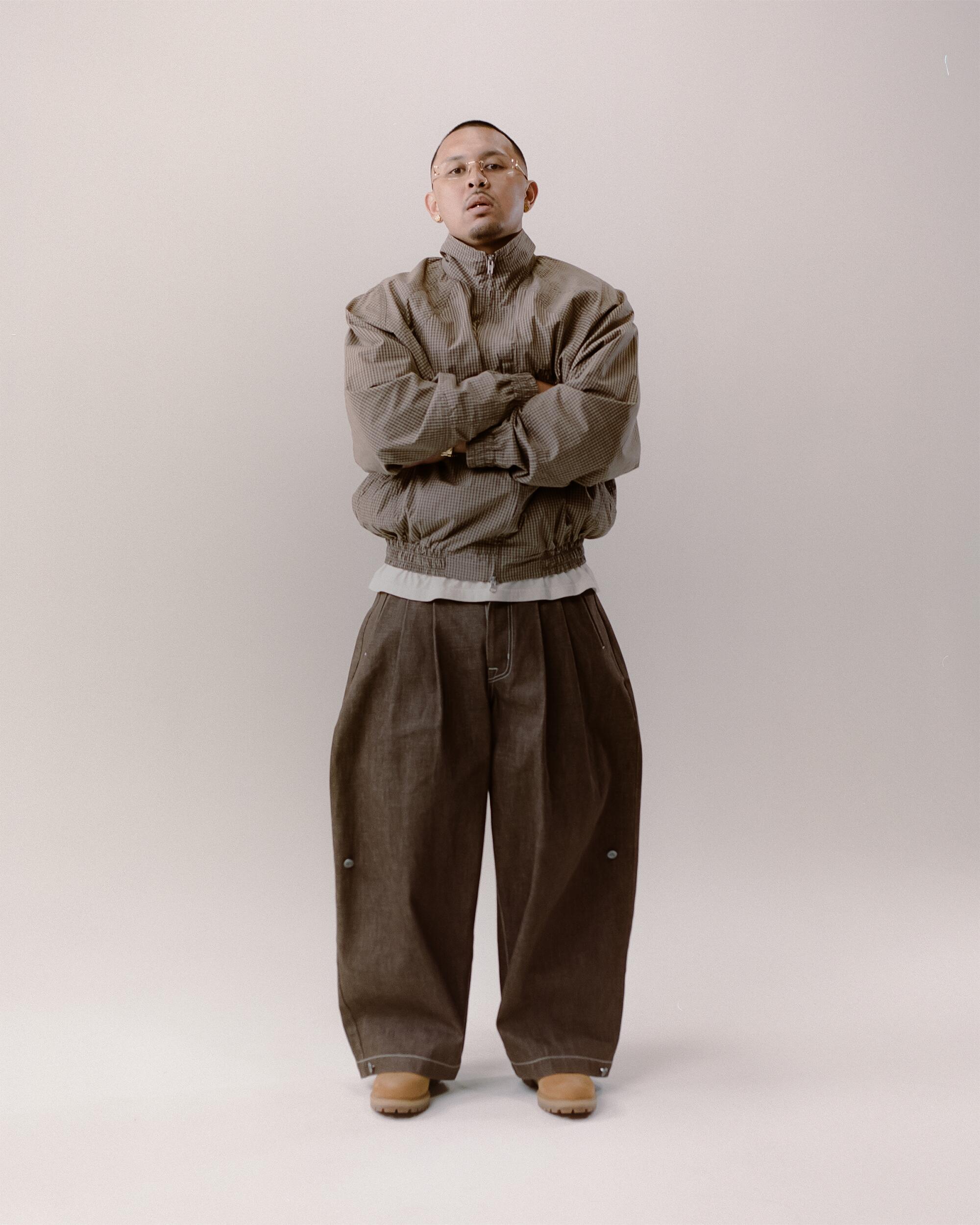 P-Lo wears Art Community Japanese way overgarment and Structured Triptych Japanese Denim pants, FAMILY by Coen Clemente Cross