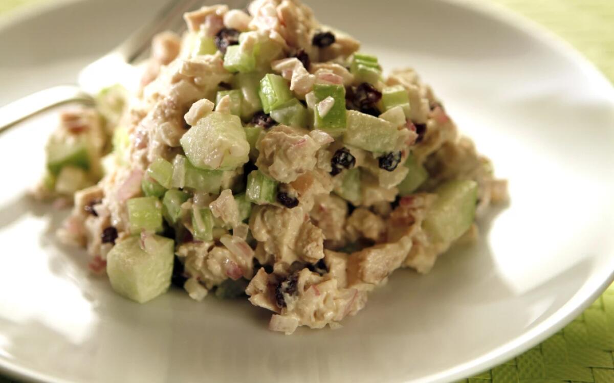 A mixture of diced chicken and green apple.