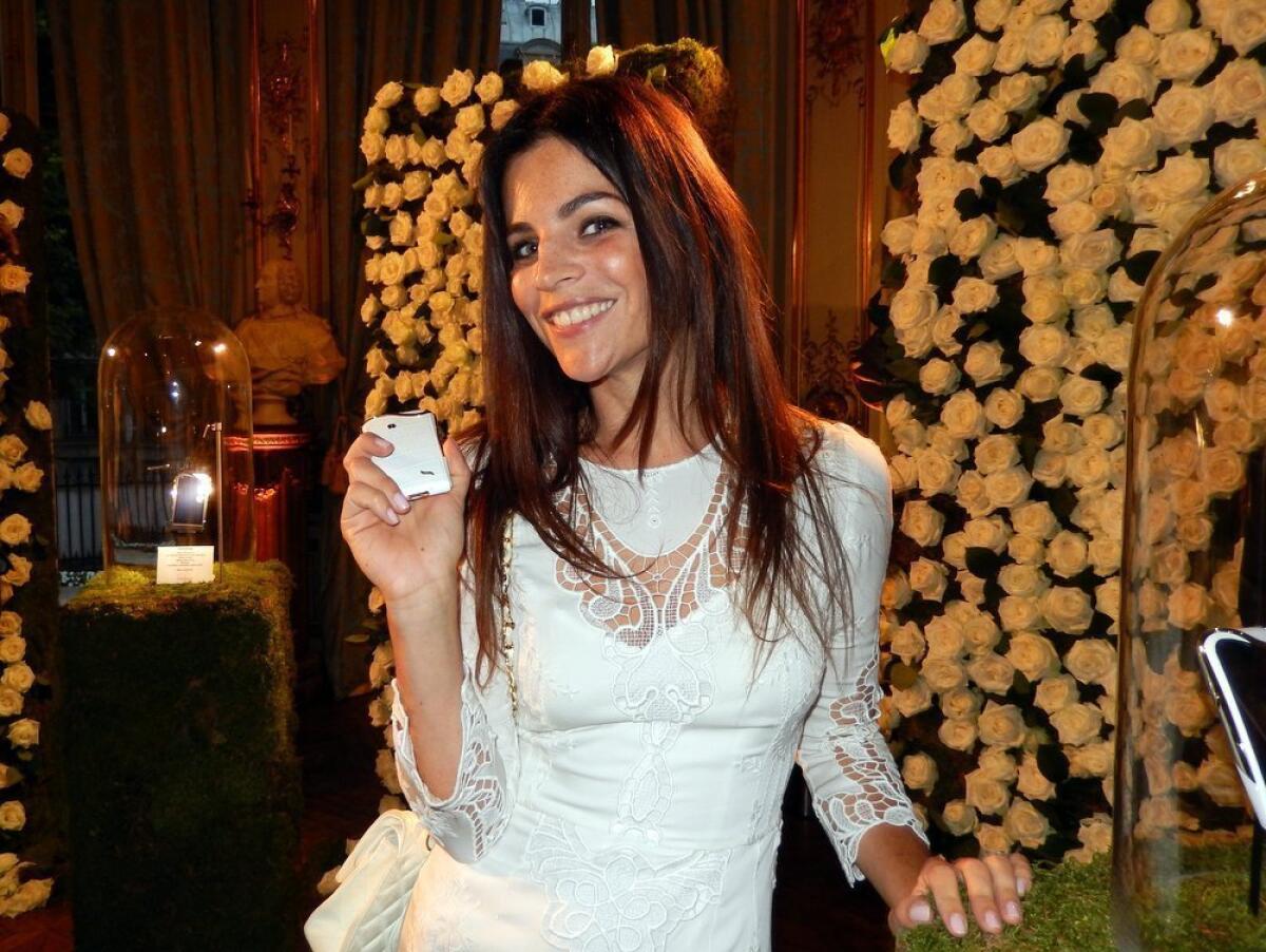Julia Restoin Roitfeld shows off one of the new luxury cellphones by Savelli at a party in Paris on Wednesday.