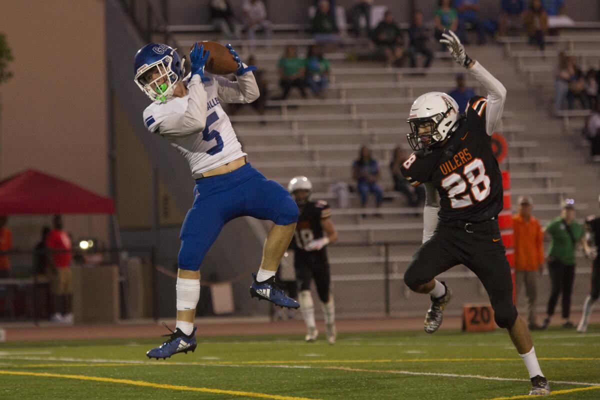 Colin Rerecich of Henderson (Nev.) Green Valley catches a 33-yard touchdown pass against Huntington Beach in the second quarter of a season opener at Cap Sheue Field on Friday.