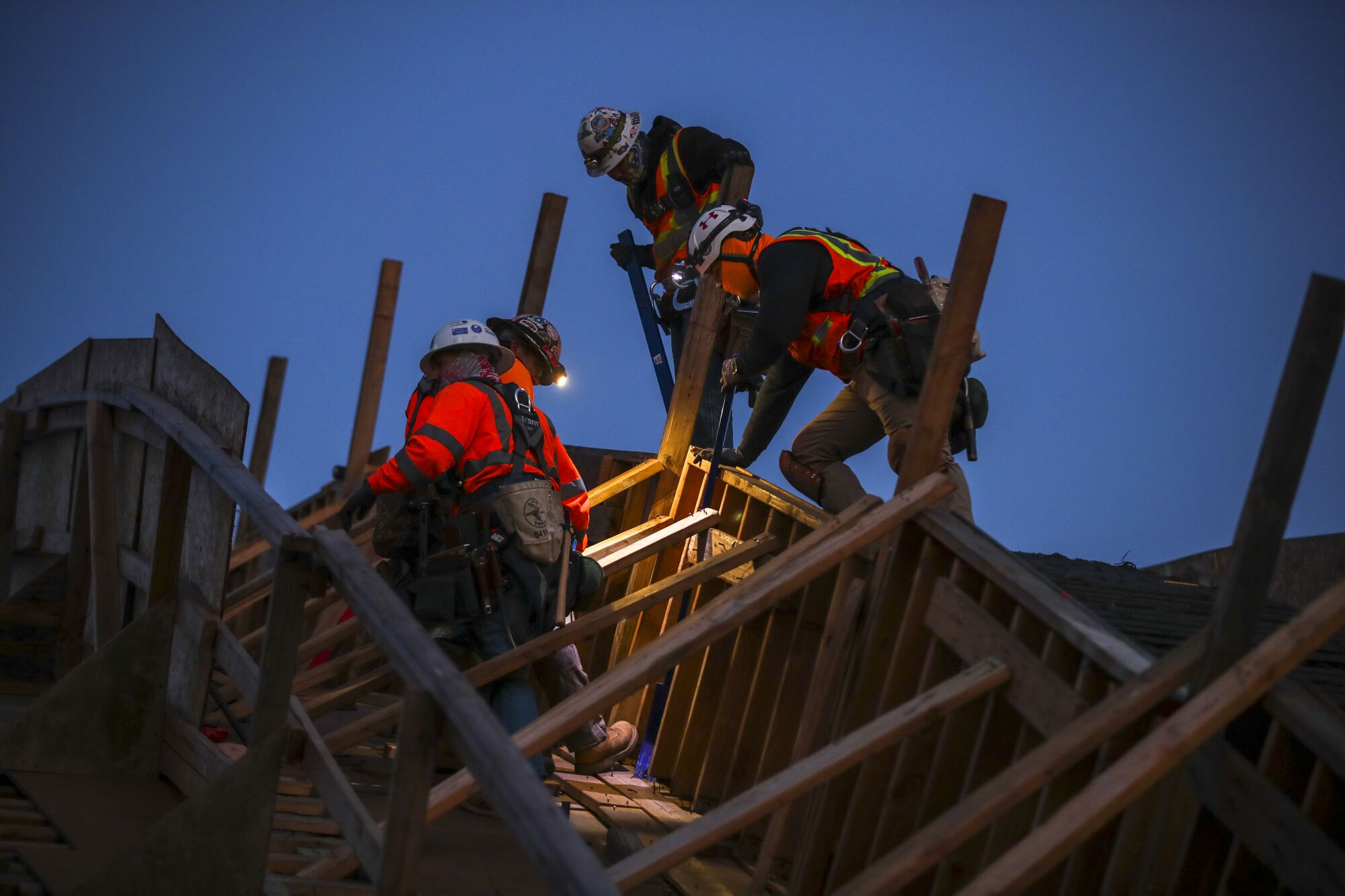 Workers build wooden framework for an arch 