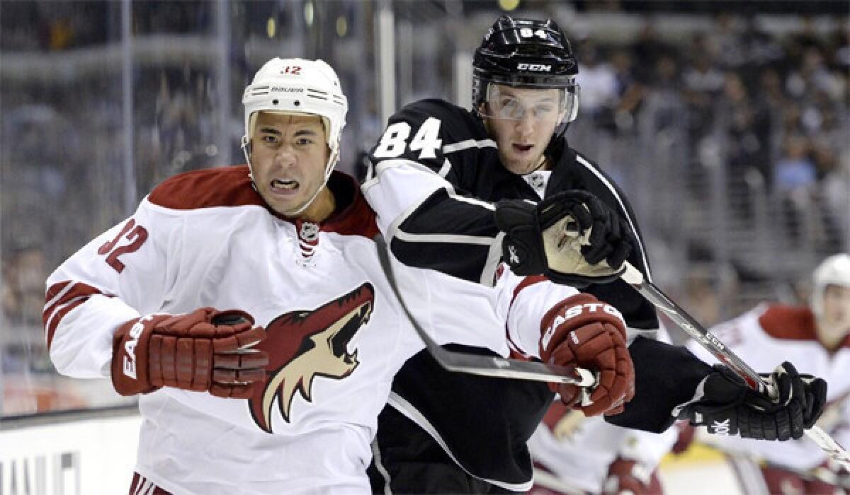 Coyotes right wing Brandon Yip battles with Kings defenseman Derek Forbort during a split squad meeting of the two clubs at Staples Center on Sunday.