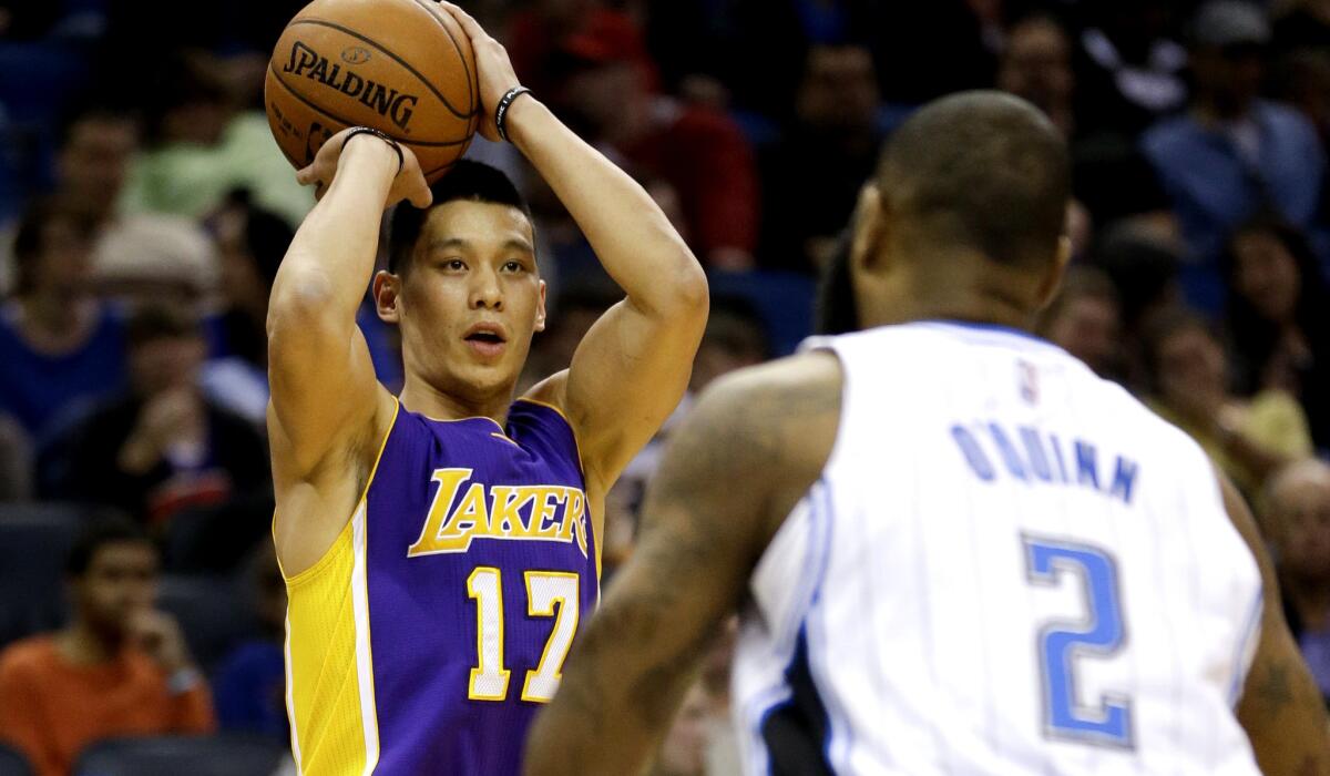 Lakers point guard Jeremy Lin prepares to shoot a three-pointer, which he made, against the Magic in the first half.