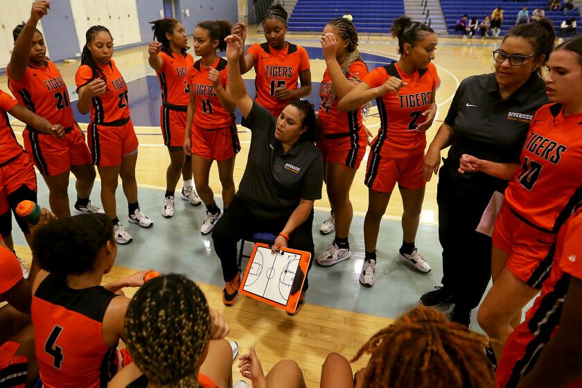 SANTA MONICA, CALIF. - DEC. 8, 2022. Riverside City College women's basketball coach Alicia Berber huddles with her team during a game against Santa Monica City College on Thursday, Dec. 8, 2022. Berber has filed a discrimination lawsuit arguing she has been the target of relentless bullying for years after protesting poor treatment of the basketball program and staff. (Luis Sinco / Los Angeles Times)