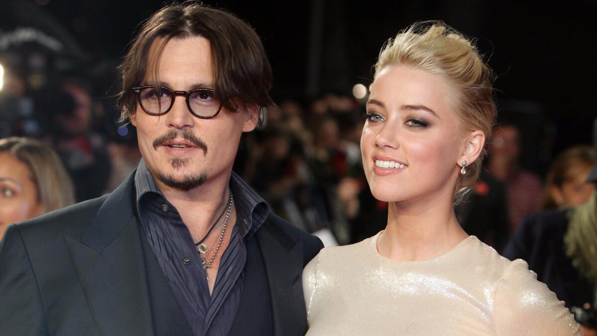 Actors Johnny Depp, left, and Amber Heard attend "The Rum Diary" premiere in London on Nov. 3, 2011.