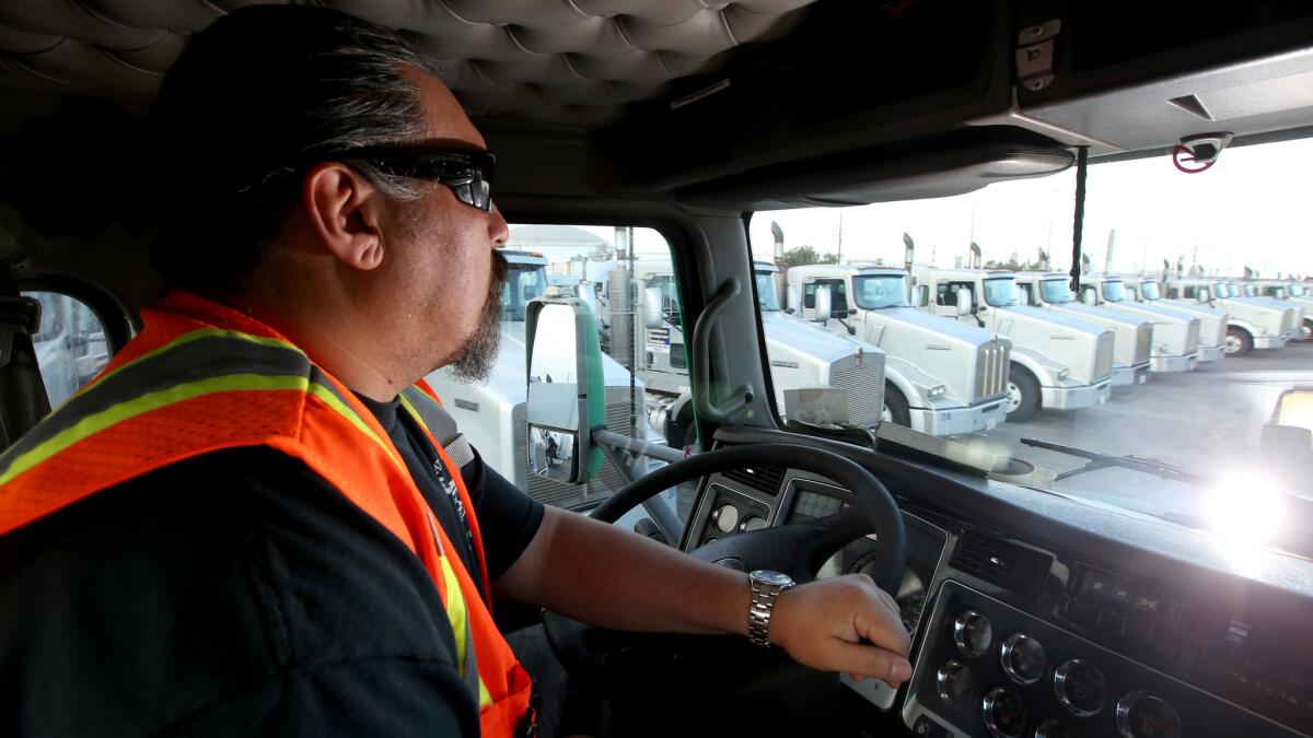 Truck driver Scott Spindola maneuvers his big rig around the Shippers Transport Express yard in Carson.