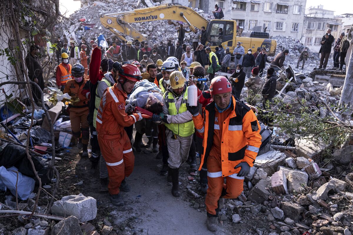 Rescue workers and medics pull out a person from a collapsed building in Antakya, Turkey, on Feb. 15.