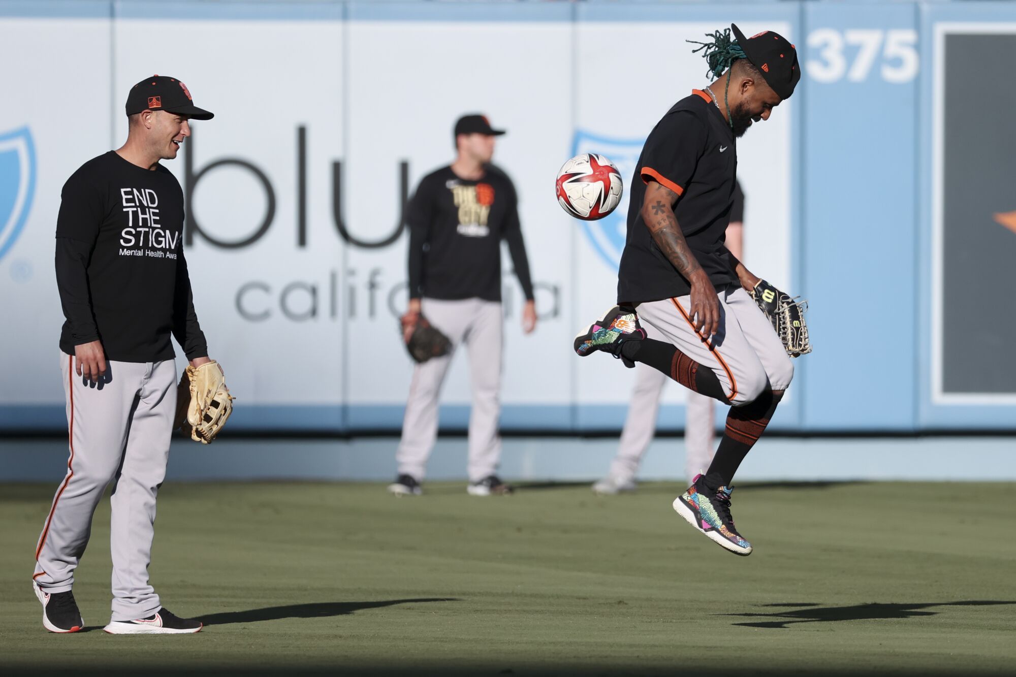  Giants' Camilo Doval kicks around a soccer ball.