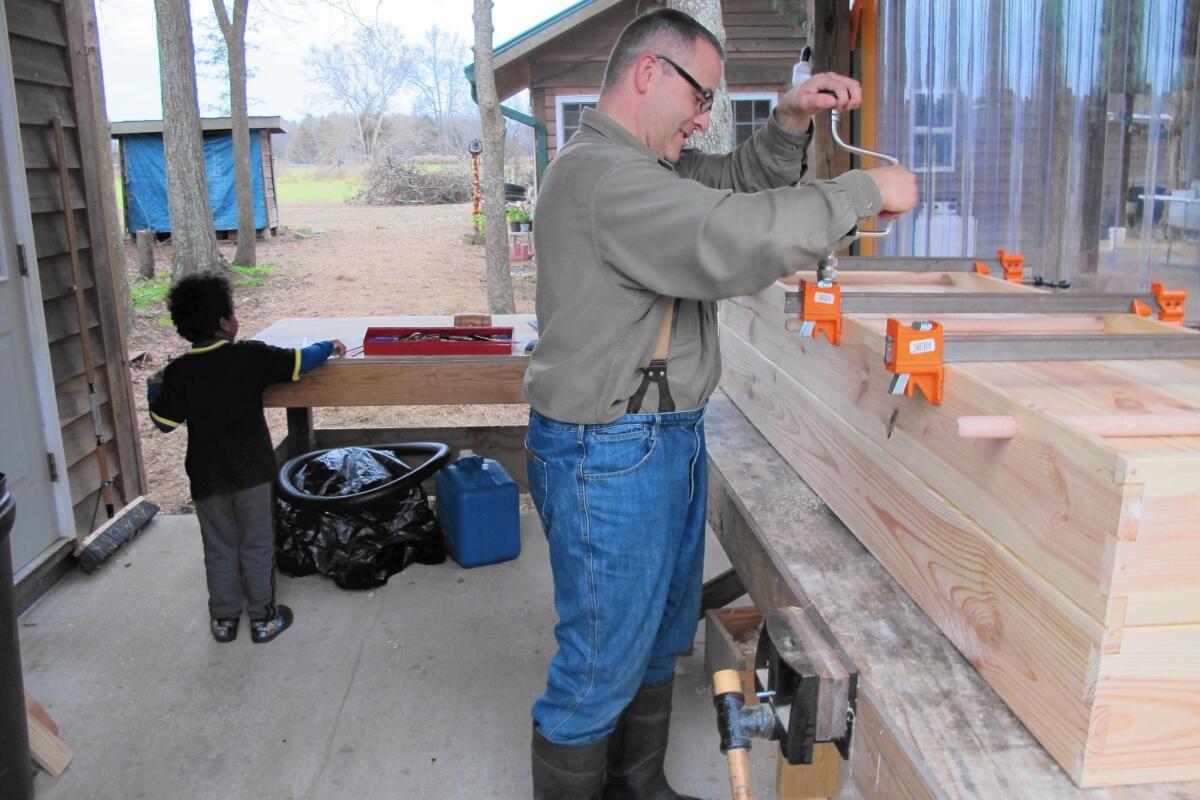 Don Byrne makes pine coffins by hand on his homestead in Bear Creek, N.C., where he lives with his wife and two children including Niko, 4.