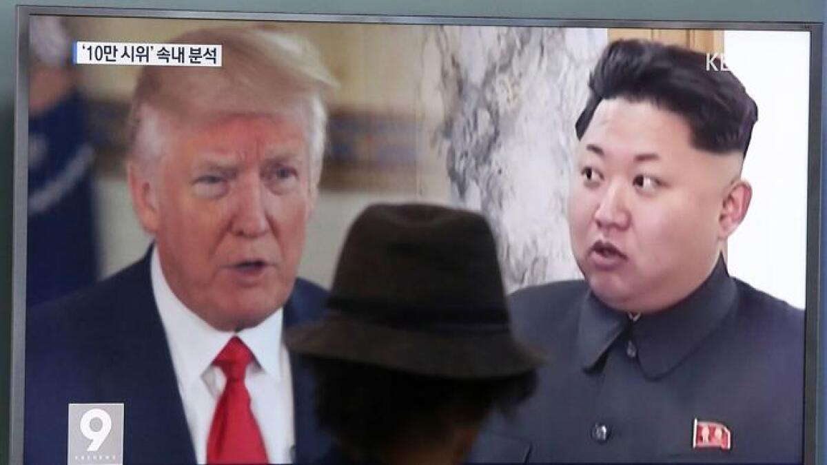 A television screen in Seoul, South Korea, shows President Trump and North Korean leader Kim Jong Un on Aug. 10.