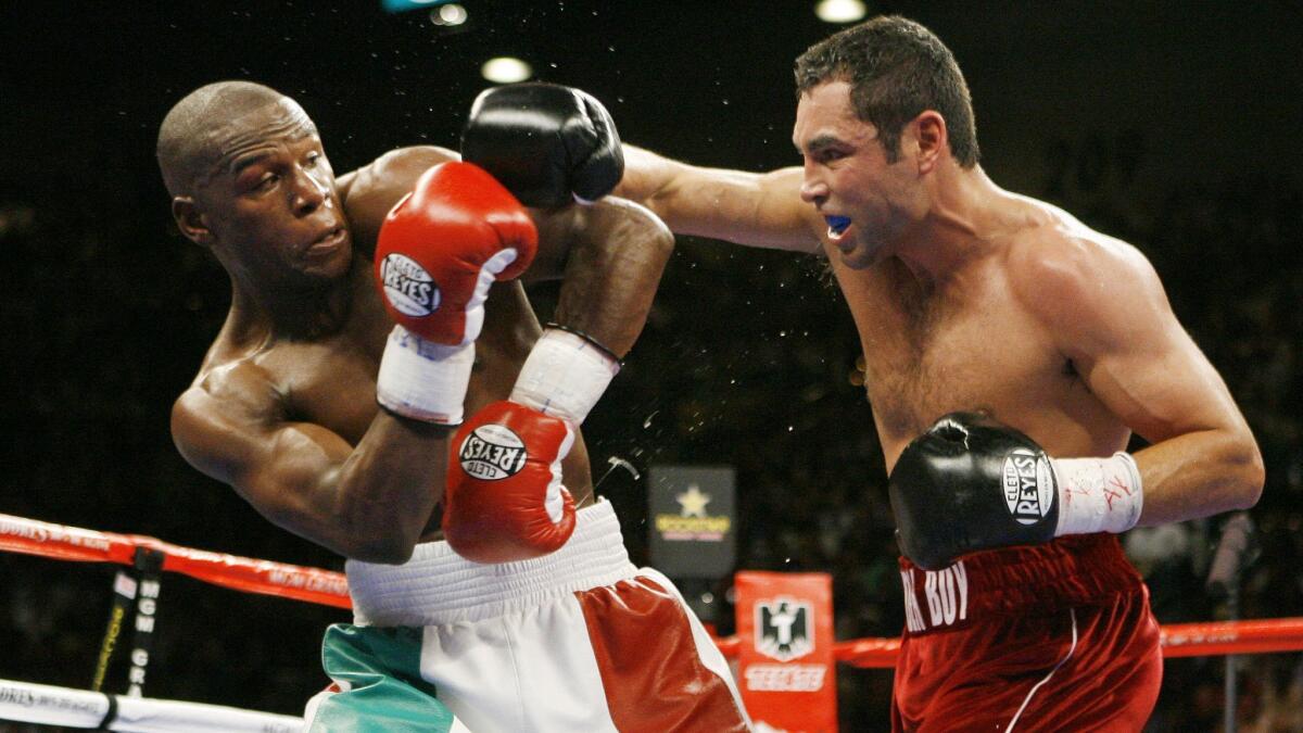 Oscar De La Hoya, right, lands a right on Floyd Mayweather Jr. during their WBC super welterweight world championship match on May 5, 2007, at the MGM Grand in Las Vegas.